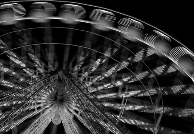 Illuminated ferris wheel at night Illuminated ferris wheel at night